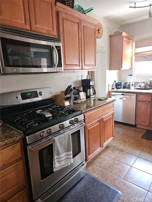 4183 4th Ave, Los Angeles, CA 90008 - kitchen with stainless steel appliances, light tile patterned floors, and dark stone counters