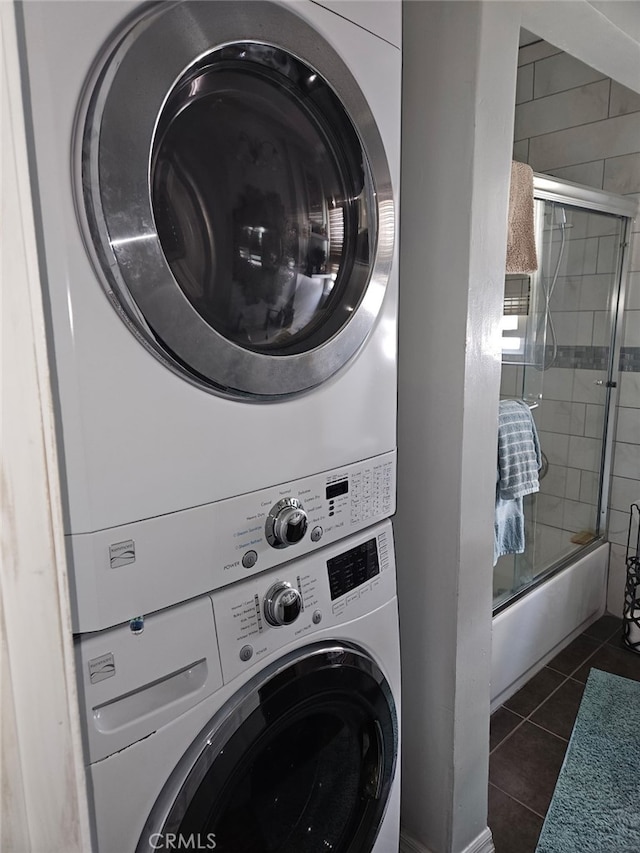 4183 4th Ave, Los Angeles, CA 90008 - washroom with stacked washer and clothes dryer and dark tile patterned flooring