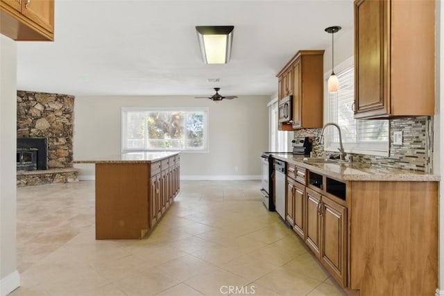 56620 Hidden Gold Dr, Yucca Valley, CA 92284 - kitchen with a sink, stainless steel appliances, ceiling fan, brown cabinets, and backsplash