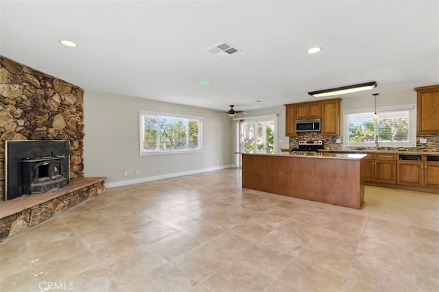 56620 Hidden Gold Dr, Yucca Valley, CA 92284 - kitchen with appliances with stainless steel finishes, open floor plan, brown cabinets, and recessed lighting