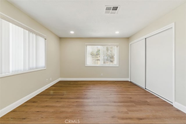 56620 Hidden Gold Dr, Yucca Valley, CA 92284 - unfurnished bedroom with wood finished floors, a closet, recessed lighting, and baseboards