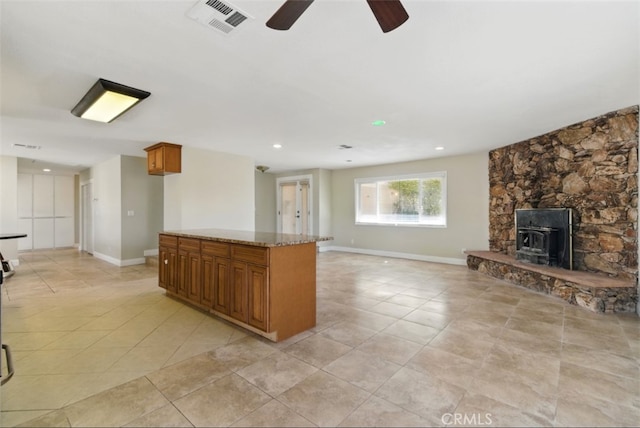56620 Hidden Gold Dr, Yucca Valley, CA 92284 - kitchen with brown cabinetry, a ceiling fan, open floor plan, baseboards, and recessed lighting