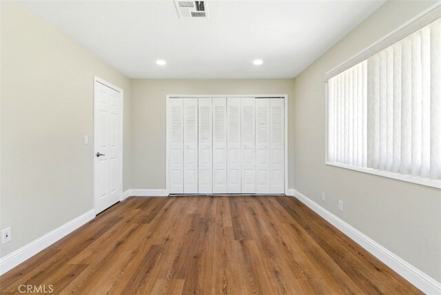56620 Hidden Gold Dr, Yucca Valley, CA 92284 - unfurnished bedroom with baseboards, wood finished floors, a closet, and recessed lighting