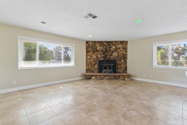 56620 Hidden Gold Dr, Yucca Valley, CA 92284 - unfurnished living room featuring light tile patterned floors, baseboards, a stone fireplace, and recessed lighting