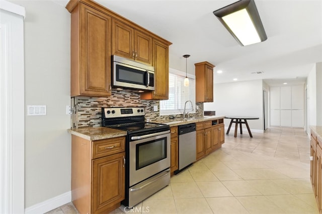 56620 Hidden Gold Dr, Yucca Valley, CA 92284 - kitchen with appliances with stainless steel finishes, brown cabinetry, backsplash, a sink, and recessed lighting