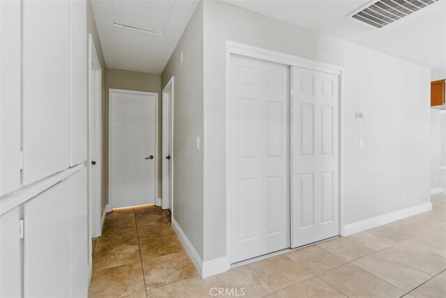 56620 Hidden Gold Dr, Yucca Valley, CA 92284 - corridor with light tile patterned floors, baseboards, and attic access