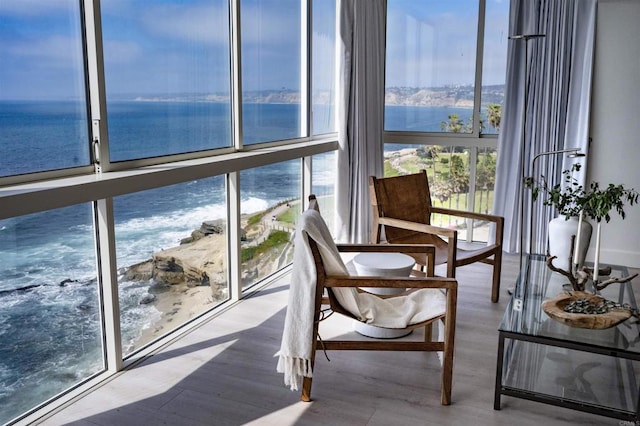 sunroom / solarium featuring a water view