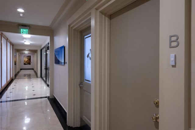 hall featuring tile patterned flooring, baseboards, french doors, and ornamental molding