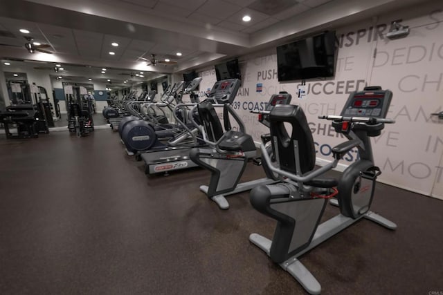 workout area featuring a paneled ceiling and recessed lighting