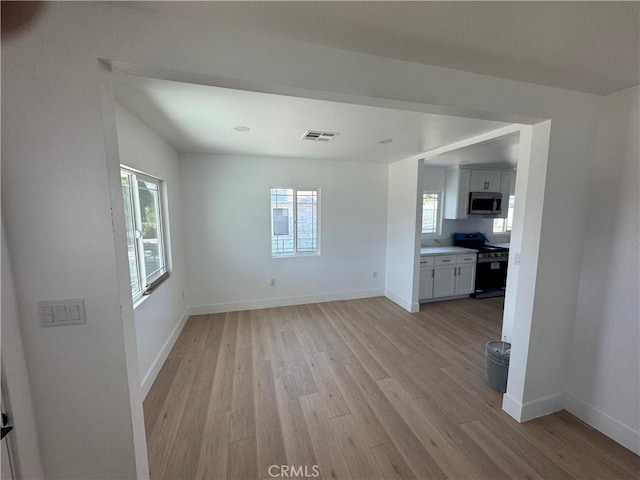 unfurnished room featuring light wood-style floors and baseboards