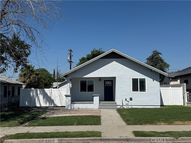 bungalow with stucco siding and a porch