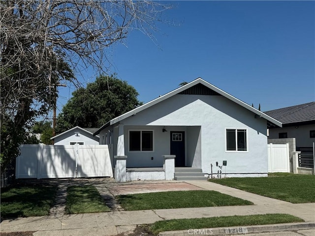 bungalow-style home with stucco siding and a porch