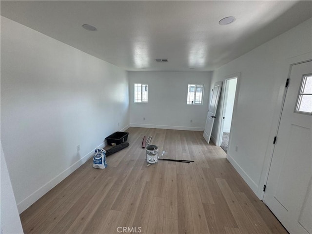 unfurnished living room featuring wood finished floors and baseboards