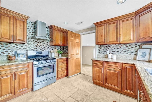 15605 Facilidad St, Hacienda Heights, CA 91745 - kitchen featuring stainless steel gas range, wall chimney exhaust hood, brown cabinets, decorative backsplash, and recessed lighting