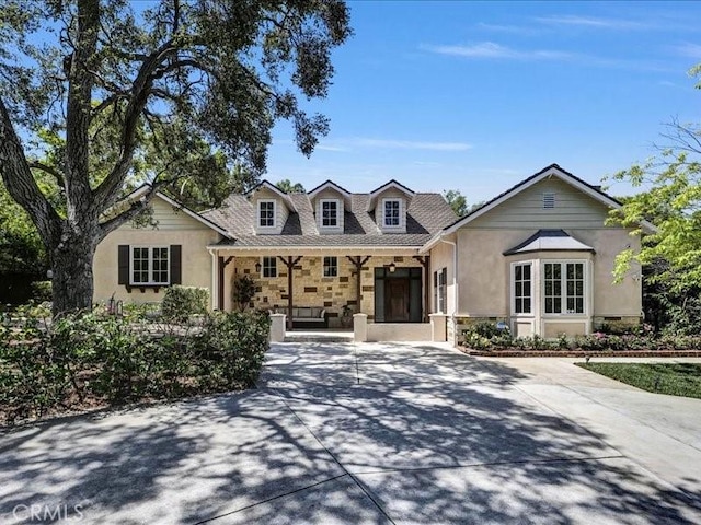 2560 Raleigh Dr, San Marino, CA 91108 - view of front facade featuring covered porch, stucco siding, and stone siding