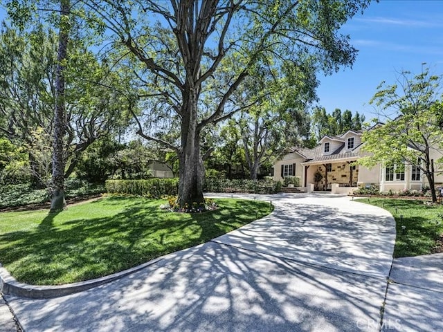 2560 Raleigh Dr, San Marino, CA 91108 - view of front of house featuring a front yard, curved driveway, and stucco siding