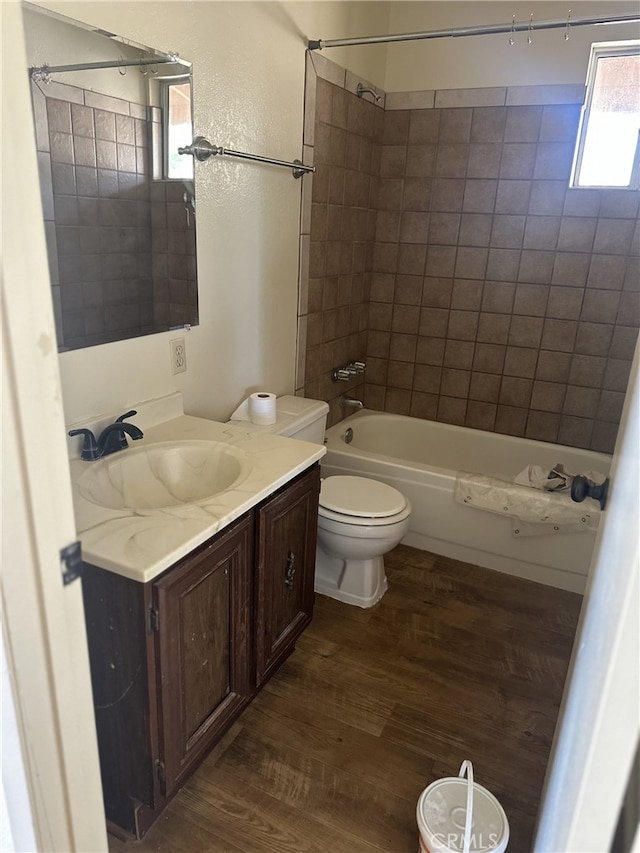 9238 Bonita Vis, Apple Valley, CA 92308 - full bathroom featuring wood finished floors, toilet, washtub / shower combination, and vanity