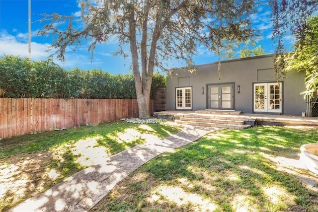 1301 N Orange Grove Ave, West Hollywood, CA 90046 - back of house with french doors and stucco siding