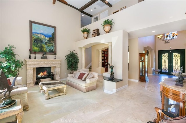 7280 Brandon Ct, Riverside, CA 92506 - living room featuring a high ceiling, a chandelier, a premium fireplace, baseboards, and stairs