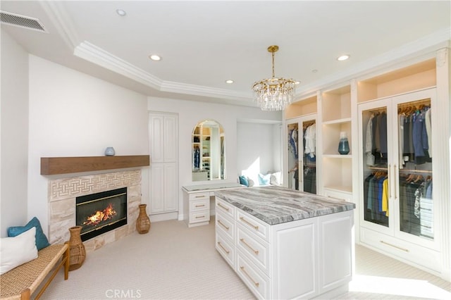 7280 Brandon Ct, Riverside, CA 92506 - spacious closet featuring light carpet, a chandelier, a glass covered fireplace, and a tray ceiling