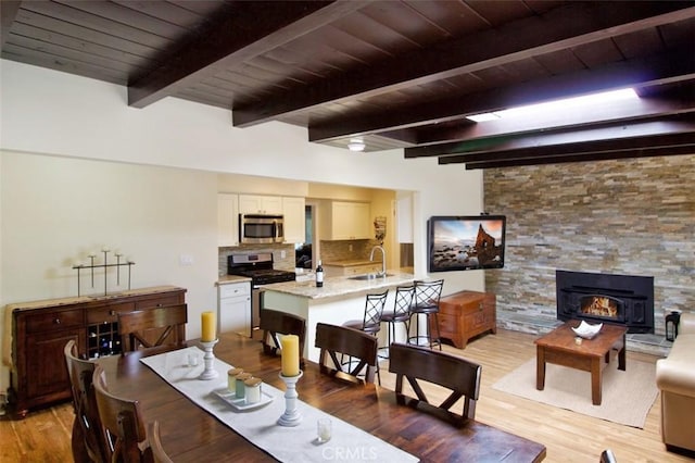 7391 Margerum Ave, San Diego, CA 92120 - dining room with light wood-style floors and wooden ceiling with exposed beams
