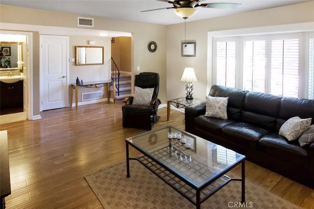 7391 Margerum Ave, San Diego, CA 92120 - living area with ceiling fan, baseboards, stairs, and wood finished floors