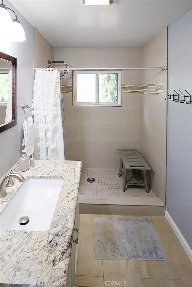 7391 Margerum Ave, San Diego, CA 92120 - bathroom with plenty of natural light, a tile shower, and vanity