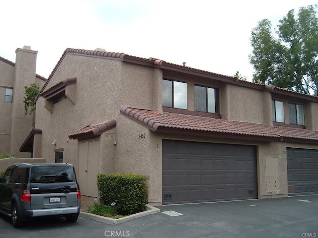 2452 Chandler Ave Unit 1, Simi Valley, CA 93065 - townhome / multi-family property featuring an attached garage, a tile roof, and stucco siding