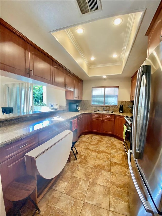 14919 Dickens St Unit 105, Sherman Oaks, CA 91403 - kitchen featuring appliances with stainless steel finishes, ornamental molding, tasteful backsplash, a tray ceiling, and a sink