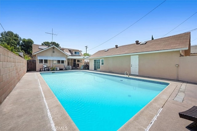 view of pool featuring fence and a patio