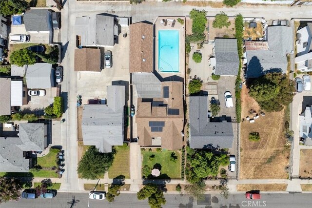 aerial overview of property's location with nearby suburban area and a pool area