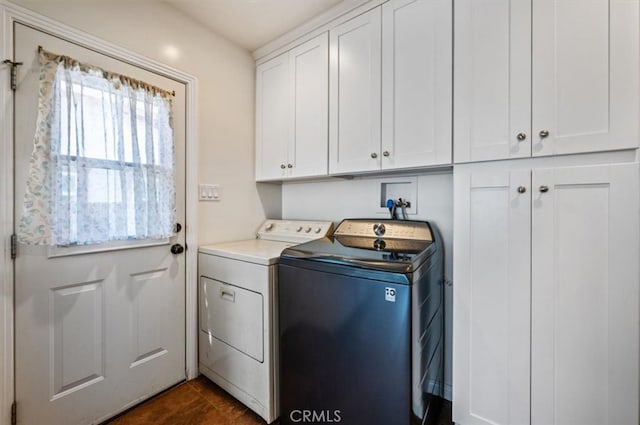 washroom featuring independent washer and dryer and cabinet space