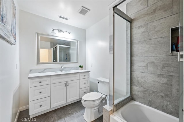 bathroom with a stall shower, toilet, vanity, a bath, and tile patterned floors