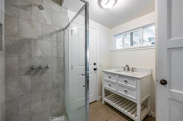 bathroom with a stall shower, tile patterned floors, and vanity