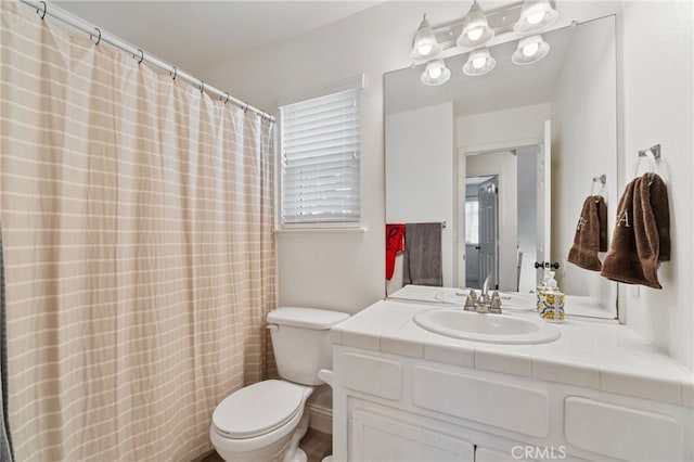 bathroom featuring toilet and vanity