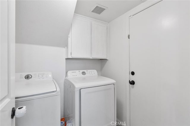 laundry room featuring cabinet space and washer and clothes dryer