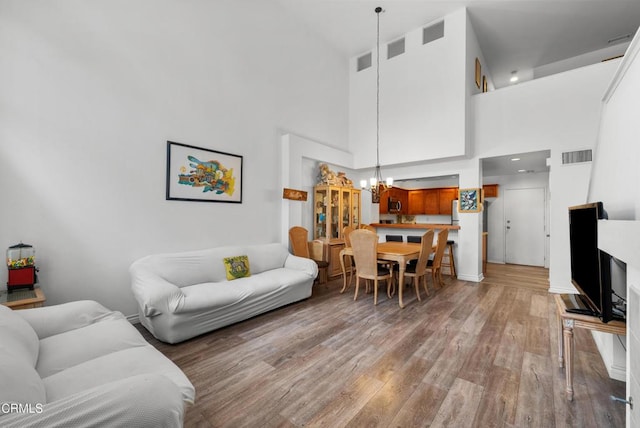 1219 Lost Point Ln, Oxnard, CA 93030 - living room with a chandelier, wood finished floors, and a towering ceiling