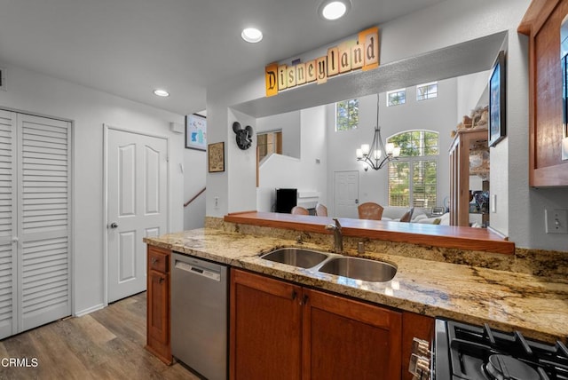 1219 Lost Point Ln, Oxnard, CA 93030 - kitchen featuring stainless steel dishwasher, a sink, wood finished floors, brown cabinetry, and light stone counters