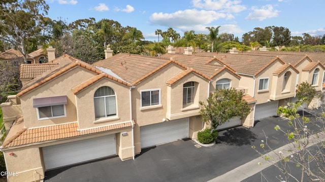 1219 Lost Point Ln, Oxnard, CA 93030 - view of front of home with stucco siding, a garage, driveway, and a tile roof
