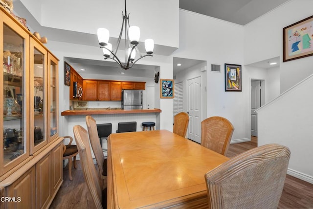 1219 Lost Point Ln, Oxnard, CA 93030 - dining room with a chandelier, dark wood-style flooring, baseboards, recessed lighting, and a high ceiling