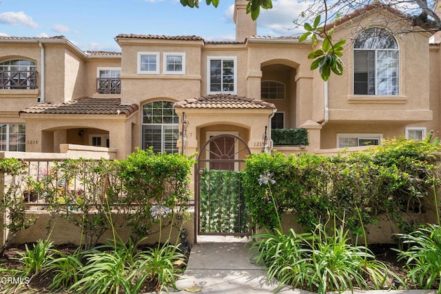1219 Lost Point Ln, Oxnard, CA 93030 - mediterranean / spanish-style home featuring stucco siding, a tile roof, and a chimney
