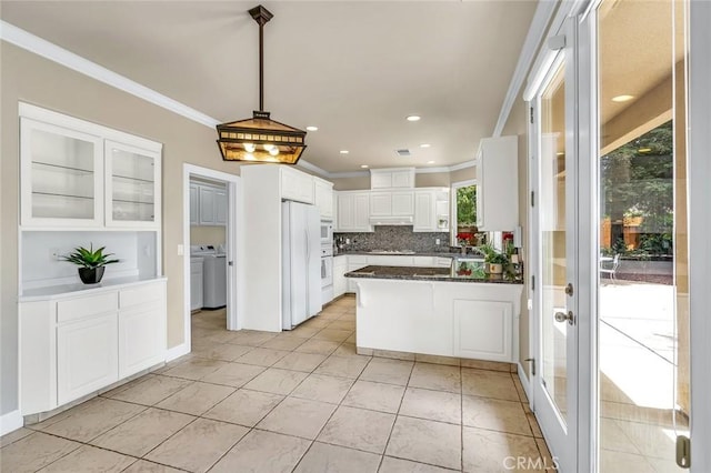 3384 Locksley Ct, Merced, CA 95340 - kitchen featuring crown molding, white cabinetry, a peninsula, light tile patterned floors, and white appliances
