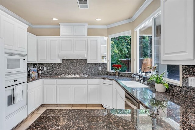 3384 Locksley Ct, Merced, CA 95340 - kitchen featuring white appliances, a sink, under cabinet range hood, white cabinets, and decorative backsplash
