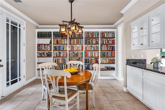 3384 Locksley Ct, Merced, CA 95340 - dining space with crown molding, a chandelier, and light tile patterned flooring