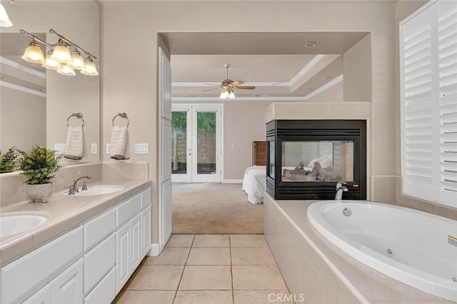 3384 Locksley Ct, Merced, CA 95340 - ensuite bathroom featuring crown molding, a whirlpool tub, a ceiling fan, tile patterned flooring, and a tray ceiling