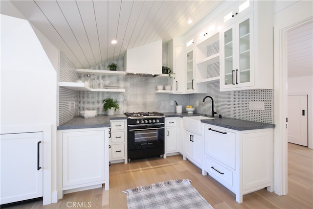 603 Pearl St, Laguna Beach, CA 92651 - kitchen featuring high end black range, open shelves, a sink, dark countertops, and vaulted ceiling