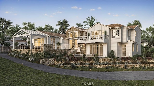 603 Pearl St, Laguna Beach, CA 92651 - view of front of house with a balcony, board and batten siding, and stone siding