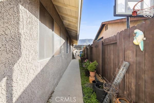 3805 Eisenhower Dr, Lake Elsinore, CA 92530 - view of side of home featuring fence and stucco siding