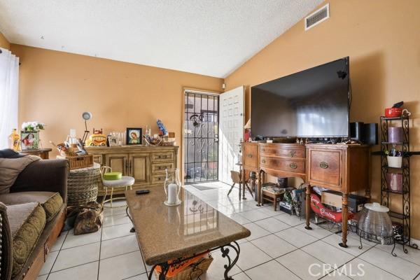 3805 Eisenhower Dr, Lake Elsinore, CA 92530 - tiled living room with lofted ceiling