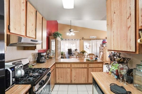 3805 Eisenhower Dr, Lake Elsinore, CA 92530 - kitchen with gas range, under cabinet range hood, lofted ceiling, ceiling fan, and light tile patterned flooring